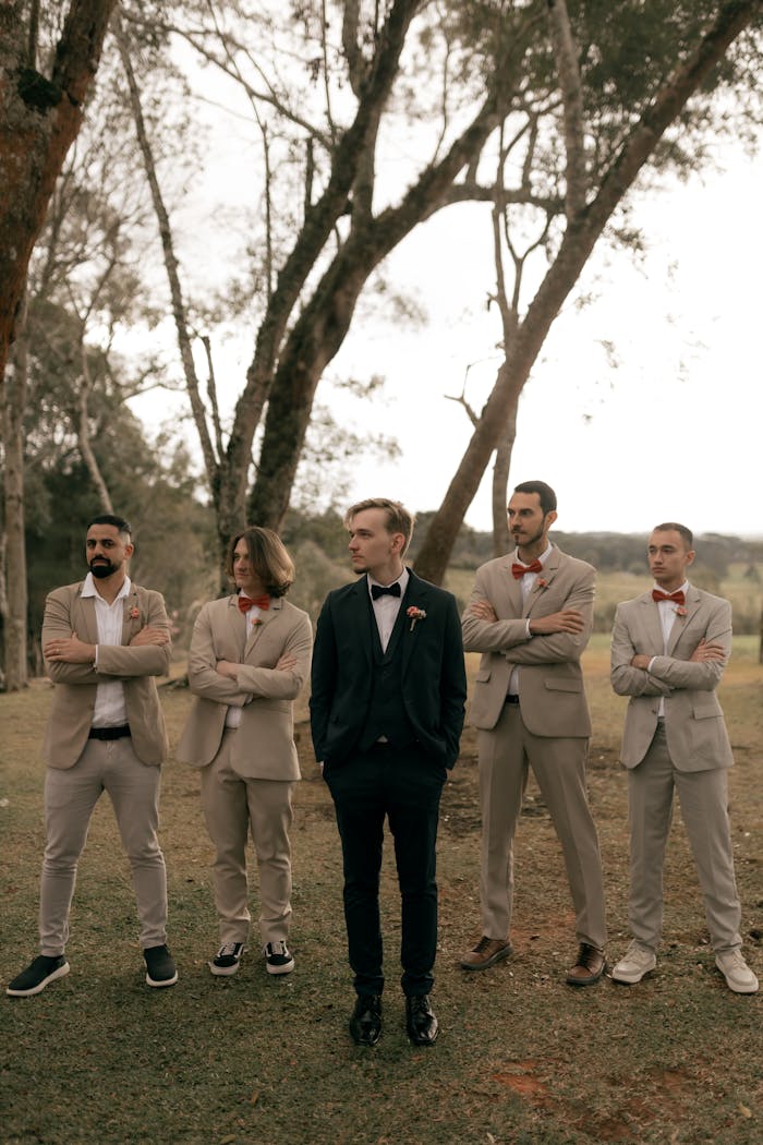 home-hero Groom with his groomsmen posing in an outdoor setting, showing elegance and style on a special day.